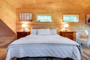 a bedroom with a large bed in a wooden room at Hiking and Snowmobile Trails On-Site Alton Retreat! in Alton Bay