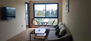 a living room with a couch and a table at Casablanca Luxury Studio - Family & Solo Friendly in Casablanca