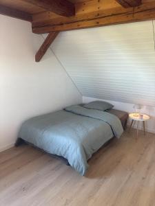 a bedroom with a bed and a table in it at Home of well-being for everyday life in Bissegg