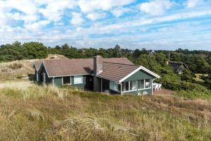 a house sitting on top of a grassy hill at FAN070-Fano-Nybyvej-58-B in Fanø