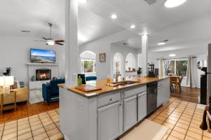 an open kitchen and living room with a fireplace at Steps From Balloon Fiesta Park Outdoor Retreat in Albuquerque