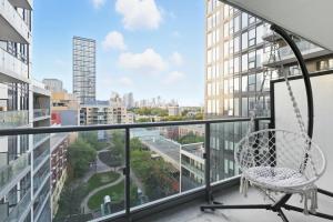 a balcony with a chair and a view of a city at Modern Studio-Style Condo in Downtown Toronto in Toronto