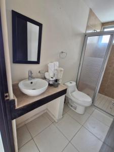 a bathroom with a sink and a toilet and a shower at Sea View 10 Boca Towers in Boca del Río