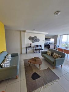 a living room with two couches and a table at Sea View 10 Boca Towers in Boca del Río