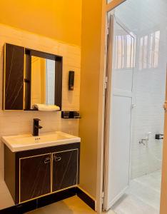 a bathroom with a sink and a shower at Cool Stay Apartments Dodoma in Dodoma