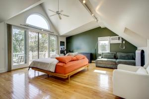 a bedroom with a bed and a living room at Walk to Marina, Park and Dtwn Cambridge Family Home in Cambridge