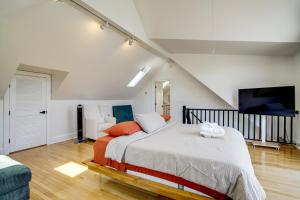 a bedroom with a large bed and a staircase at Walk to Marina, Park and Dtwn Cambridge Family Home in Cambridge