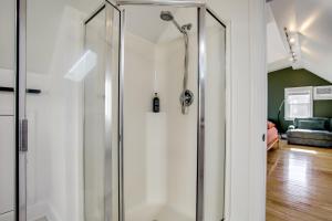 a shower in a room with a glass door at Walk to Marina, Park and Dtwn Cambridge Family Home in Cambridge +22 photos