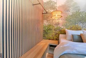 a bedroom with a bed and a wall mural at Chez Grand-Mère Cozy Retro Apartment in the Heart of Metz in Metz