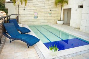 two chairs sitting next to a swimming pool at Hotel Nacional Inn Rio Copacabana in Rio de Janeiro
