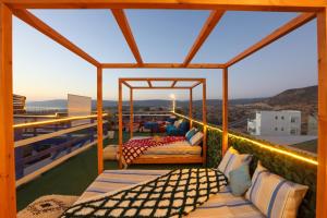 a room with two beds on a balcony at Blue Rina Hostel in Agadir