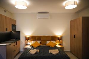 a bedroom with a bed with two pillows on it at Aparthotel CENTRUM Wrocławska 13 in Bytom