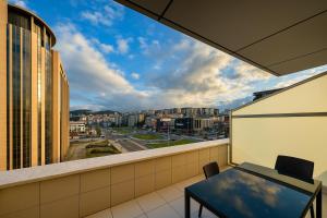a balcony with a table and a view of a city at Cevaher Hotel & Suıtes in Sancak