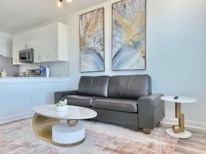 a living room with a couch and a table at Modern 1-Bedroom Condo in Downtown Atlanta 525Pkwy517 in Atlanta