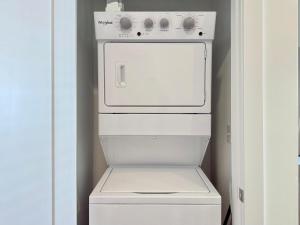 a white stove in a kitchen with a refrigerator at Modern 1-Bedroom Condo in Downtown Atlanta 525Pkwy517 in Atlanta