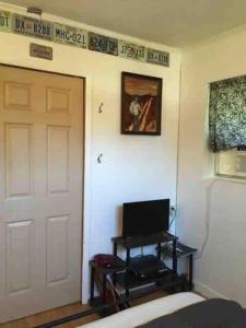 a room with a door and a television next to a door at Cozy Gulf Coast Getaway in Pensacola