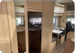 an interior of an rv with a tv in it at Parked central campervan in Höfn
