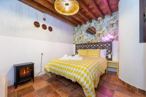 a bedroom with a bed and a fireplace at Apartamentos - PinkSparrow - in Granada