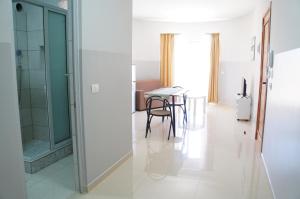 a room with a table and a glass door at Ilidia Guest House in Sal Rei