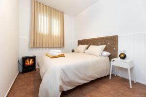 a bedroom with a large bed and a fireplace at Apartamentos - PinkSparrow - in Granada