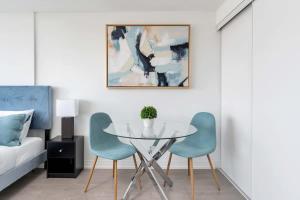 a dining room with a table and two chairs at City Lights Studio w Balcony Walk to Eaton Centre in Toronto