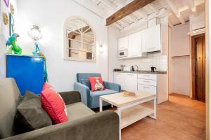 a living room with a couch and a table at Apartamentos - PinkSparrow - in Granada