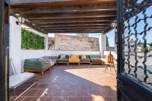 an outdoor patio with couches and a table at Apartamentos - PinkSparrow - in Granada