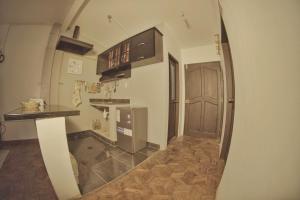 a kitchen with a refrigerator and a counter in a room at super central apartment in La Paz