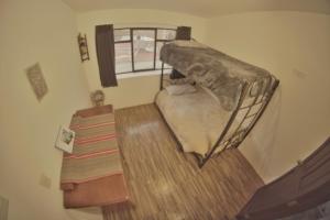 a small bedroom with a bed and a window at super central apartment in La Paz