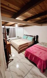 a bedroom with two beds in a room at Pousada Canto da Sereia in Ilha do Mel