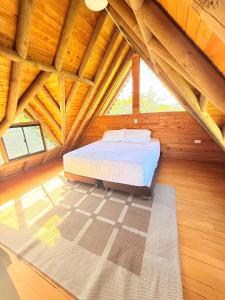 a bedroom with a bed in a wooden attic at Glamping en Rionegro in Rionegro +15 photos