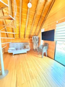 a living room with a couch and a chair at Glamping en Rionegro in Rionegro