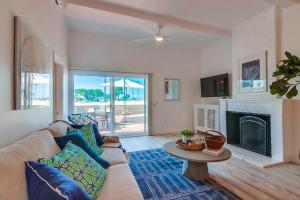 a living room with a couch and a fireplace at Jetty View 1 in San Diego