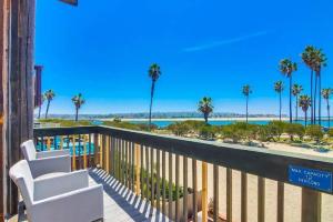 a balcony with a view of the beach and palm trees at Jetty View 2 in San Diego