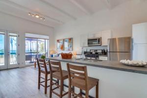 a kitchen with a bar with chairs and a counter top at Jetty View 2 in San Diego