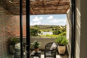 a balcony with a view of a river at Lovemore Retreat - Port Elizabeth in Gqeberha