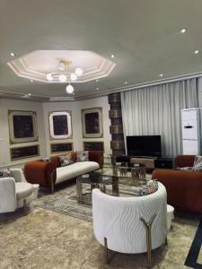 a large living room with couches and a table at beverly villa in Sheikh Zayed