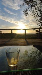 a glass bowl on a table with the sunset in the background at Casa sector Vista Hermosa primera linea in Chacurra +5 photos