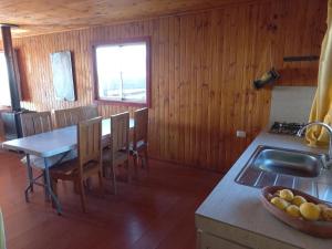 a kitchen and dining room with a table and a sink at Casa sector Vista Hermosa primera linea in Chacurra