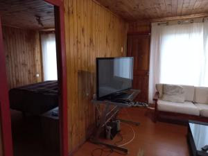 a living room with a flat screen tv and a couch at Casa sector Vista Hermosa primera linea in Chacurra