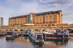 two boats are docked in the water in front of a building at Sandman Signature Sheffield Quays Hotel in Sheffield +101 photos