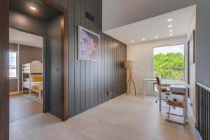 a room with a hallway with a desk and a bedroom at Socal Style in Encinitas