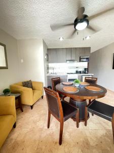 a living room with a table and chairs and a couch at Incredible Suite Cancun - BEACH CONDO - 6PX in Cancún