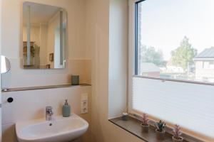 Un baño con lavabo y ventana. en Feldbrise-Fehmarn, en Fehmarn 32 fotos más