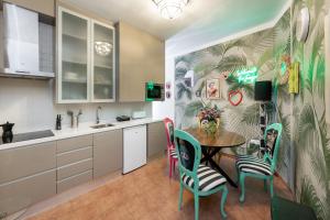 a kitchen with a table and chairs in it at Apartamentos - PinkSparrow - in Granada +60 photos