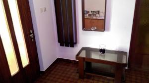 a bathroom with a table and a mirror on the wall at Rina Apartments in Labin