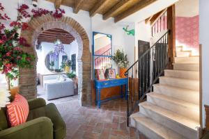 a living room with an archway and stairs at Apartamentos - PinkSparrow - in Granada