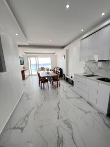 a white kitchen with a table and a dining room at Boca Beach 504, Boca Chica in Boca Chica