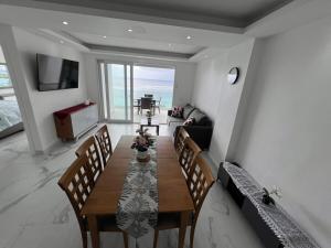 a living room with a wooden table and chairs at Boca Beach 504, Boca Chica in Boca Chica