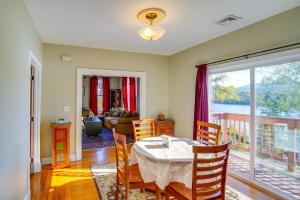 a dining room with a table and a balcony at Canal-Front Waterford Apartment on Hudson River in Waterford